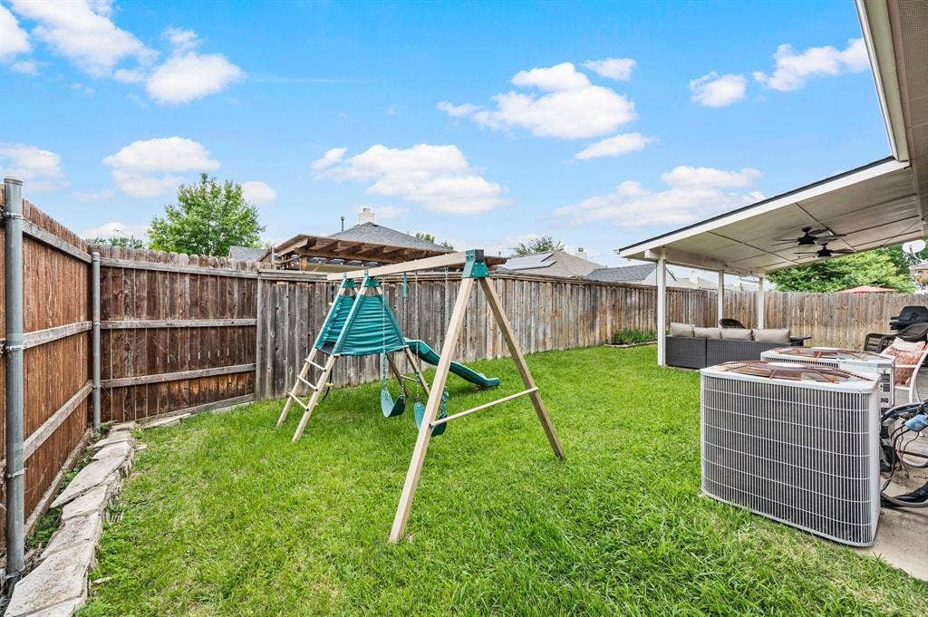 308 Bradbury Drive, Euless, TX 76040 Private backyard featuring a large grassy area ideal for pets, playsets or outdoor fun.