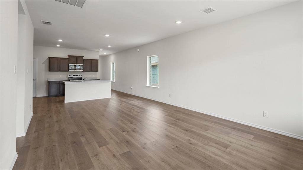 1619 Blaire Drive, Tyler, TX 75702 Open-concept living space featuring wood-finish flooring, recessed lighting, and white baseboards
