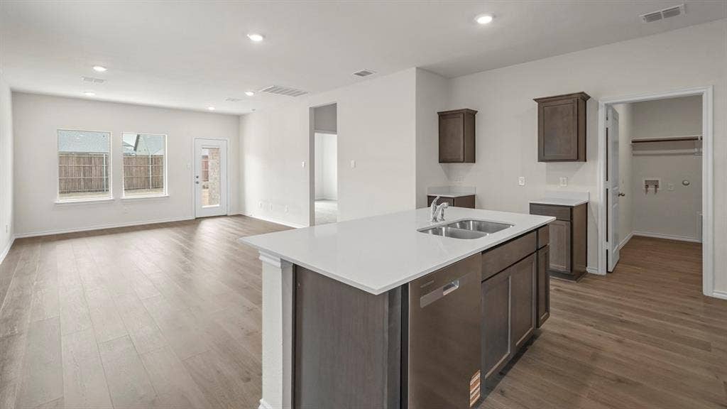 1619 Blaire Drive, Tyler, TX 75702 Open-concept living space featuring wood-finish flooring, recessed lighting, and white walls