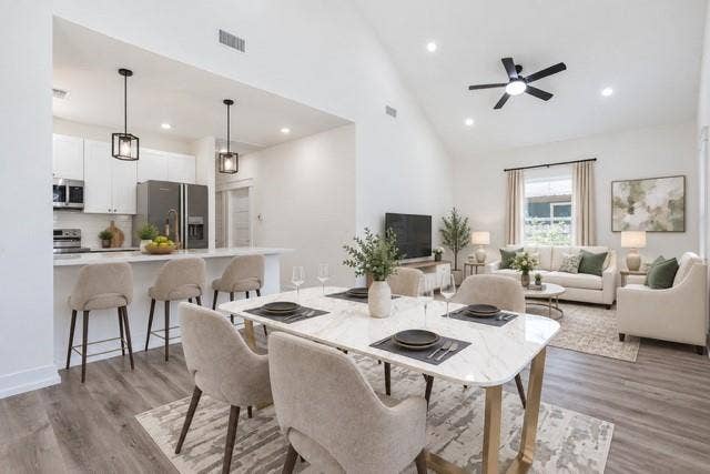 2608 Cleveland Avenue, Waco, TX 76711 Virtual staging - Open-concept living space featuring wood-finish flooring, a vaulted ceiling, and recessed lighting