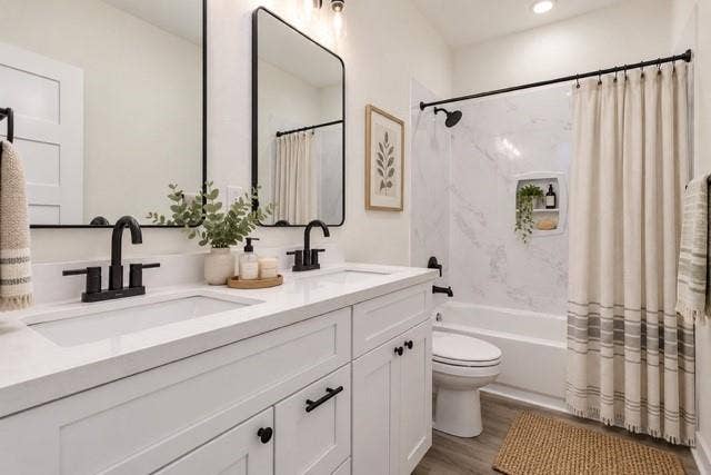 2608 Cleveland Avenue, Waco, TX 76711 Virtual staging - Double vanity with white cabinetry and integrated sinks, matte black fixtures, framed mirrors, and a shower-over-tub with a built-in niche