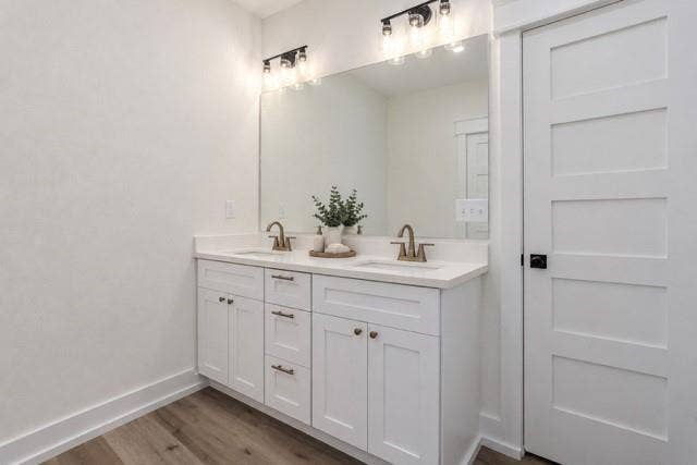 2608 Cleveland Avenue, Waco, TX 76711 Virtual staging - Dual vanity with white cabinetry, bronze-finish faucets, and an expansive mirror