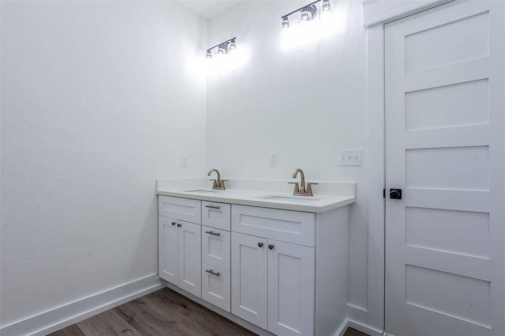 2608 Cleveland Avenue, Waco, TX 76711 Double vanity with white cabinetry, light-toned countertops, and brushed nickel faucets