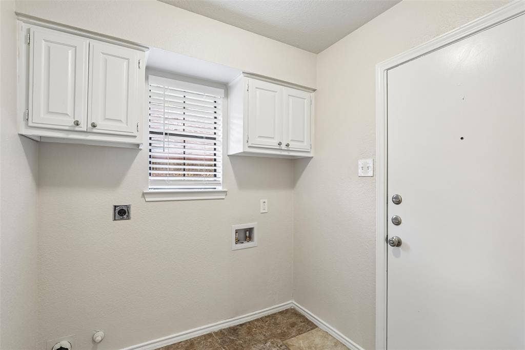 612 E Oak Street, Wylie, TX 75098 Laundry area featuring overhead cabinetry, a window with blinds, and utility connections