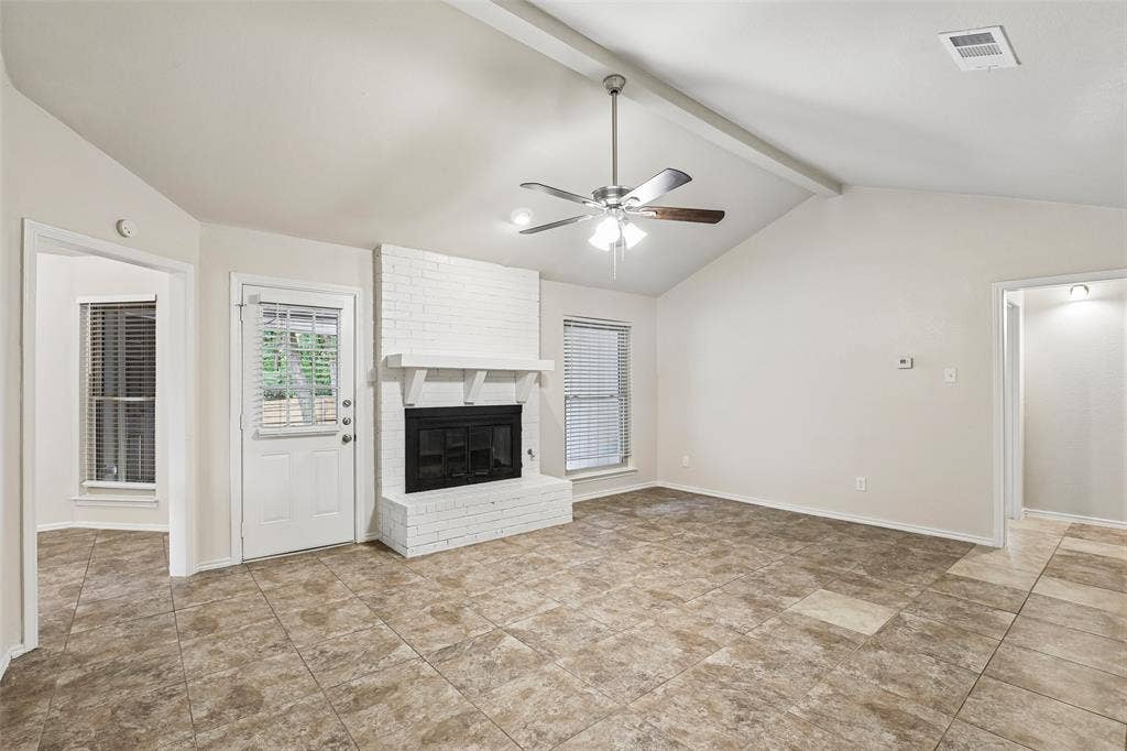 612 E Oak Street, Wylie, TX 75098 Spacious living area featuring a vaulted ceiling with exposed beams, an overhead ceiling fan, and tile flooring