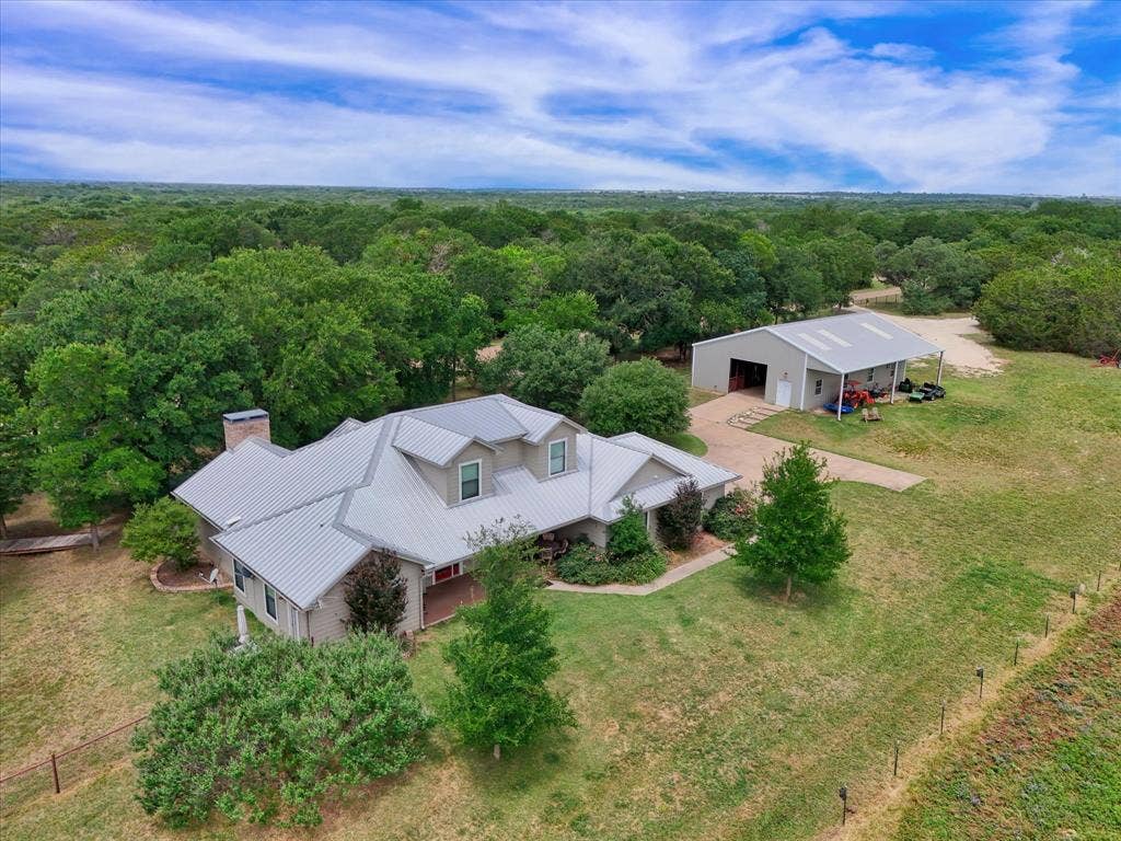 613 Bone Road, Valley Mills, TX 76689 Expansive property featuring a single-story residence with a metal roof and a detached barn