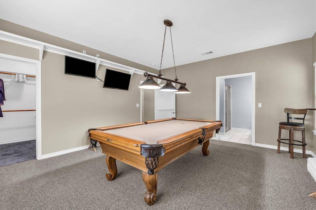 613 Bone Road, Valley Mills, TX 76689 Recreation area featuring a pool table with a multi-bulb pendant light fixture, wall-mounted display screens, and a built-in closet with shelving