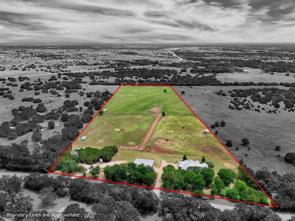 613 Bone Road, Valley Mills, TX 76689 Expansive rural property featuring two residential structures, a large open field, varied tree coverage, and a defined boundary line