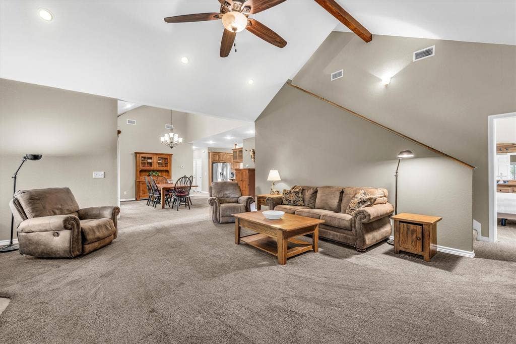 613 Bone Road, Valley Mills, TX 76689 Spacious living area featuring vaulted ceilings with exposed wood beams and a ceiling fan