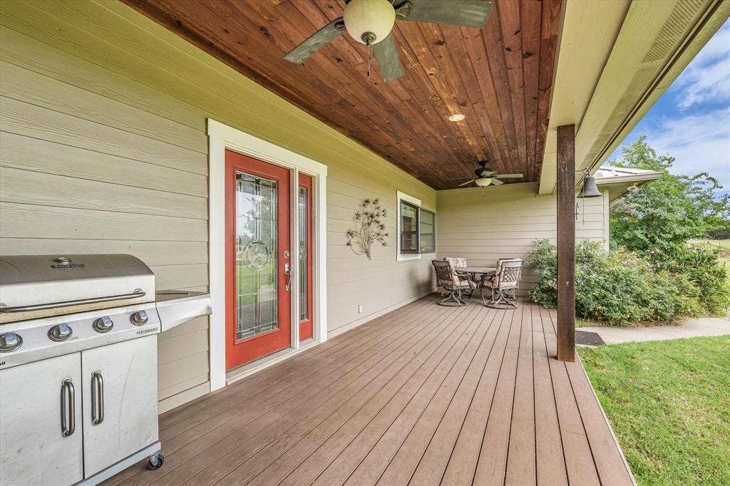 613 Bone Road, Valley Mills, TX 76689 Spacious outdoor patio featuring composite decking, a wood-paneled ceiling with two ceiling fans, and light-toned siding
