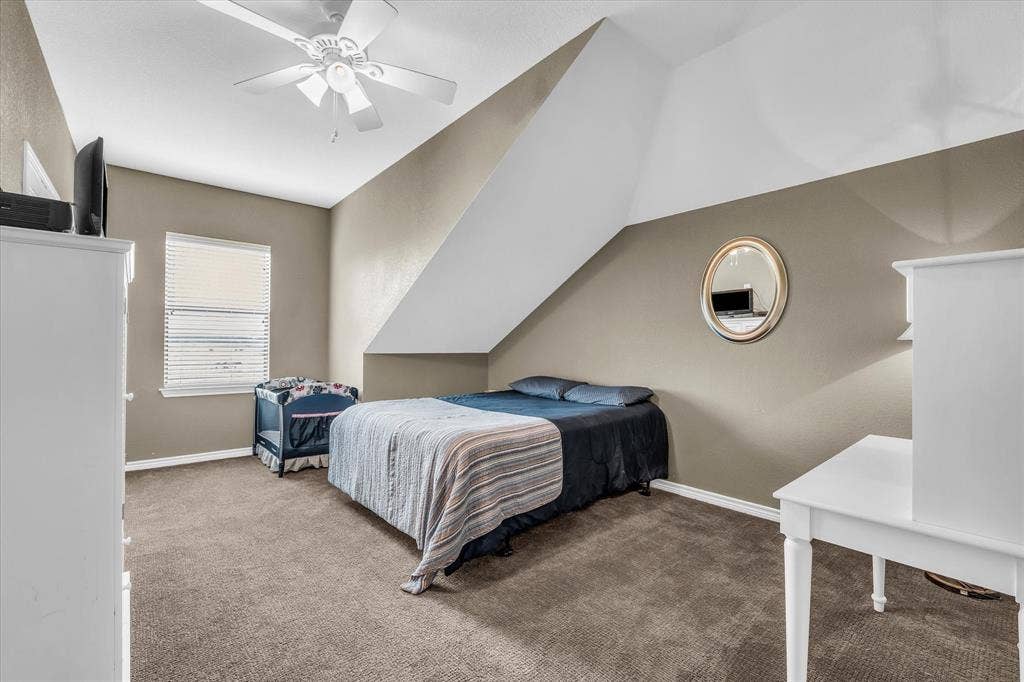 613 Bone Road, Valley Mills, TX 76689 Carpeted room with a ceiling fan, window with blinds, and sloped ceiling