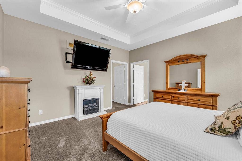 613 Bone Road, Valley Mills, TX 76689 Spacious room featuring tray ceilings with crown molding, a ceiling fan with integrated lighting, and neutral-toned wall paint