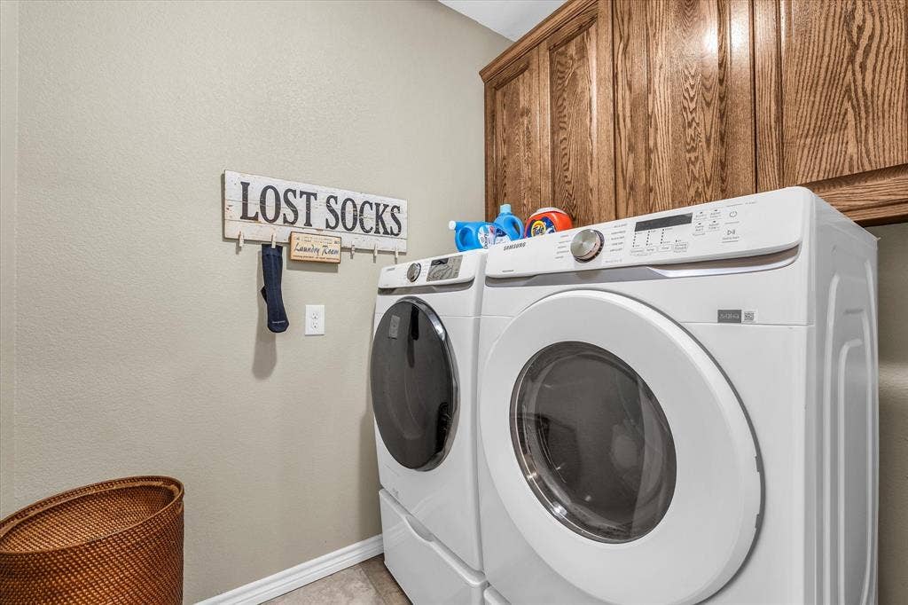 613 Bone Road, Valley Mills, TX 76689 Laundry area featuring wood-finish cabinetry and light-toned walls