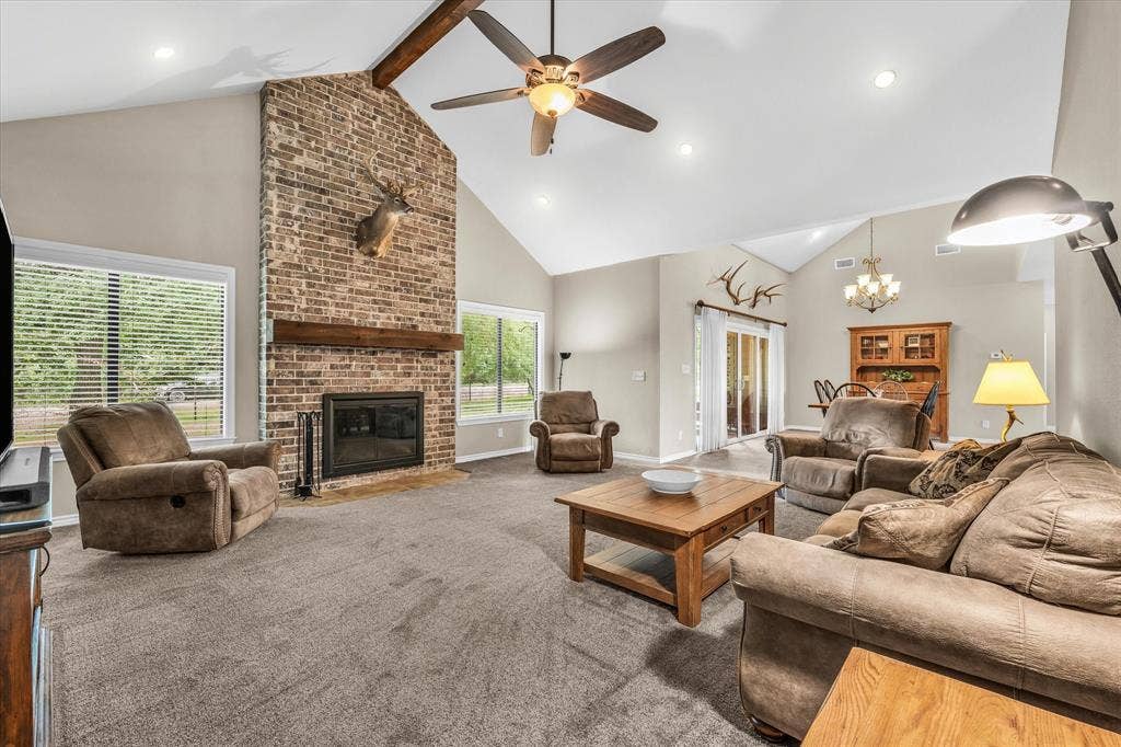 613 Bone Road, Valley Mills, TX 76689 Living area featuring a floor-to-ceiling brick fireplace with a wood mantle, vaulted ceilings, recessed lighting, and a ceiling fan