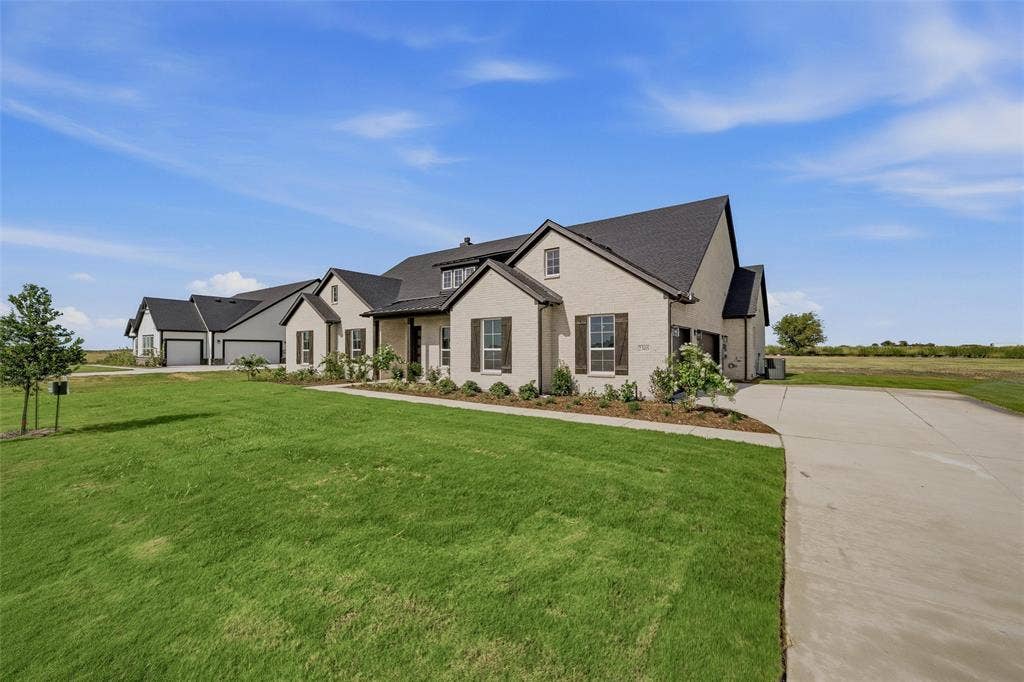 2305 Quartz Street, Krum, TX 76249 Contemporary exterior with light-toned brick and dark-toned roof