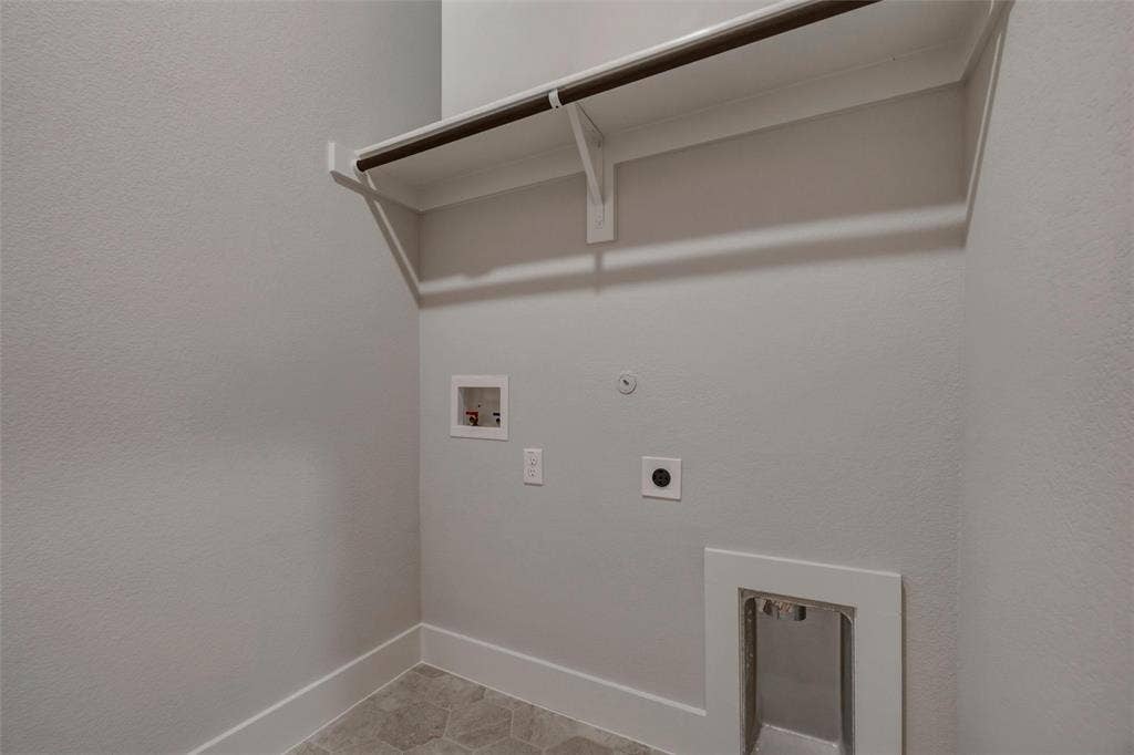 2305 Quartz Street, Krum, TX 76249 Utility room featuring a built-in shelf, hanging rod, and hexagonal tile flooring