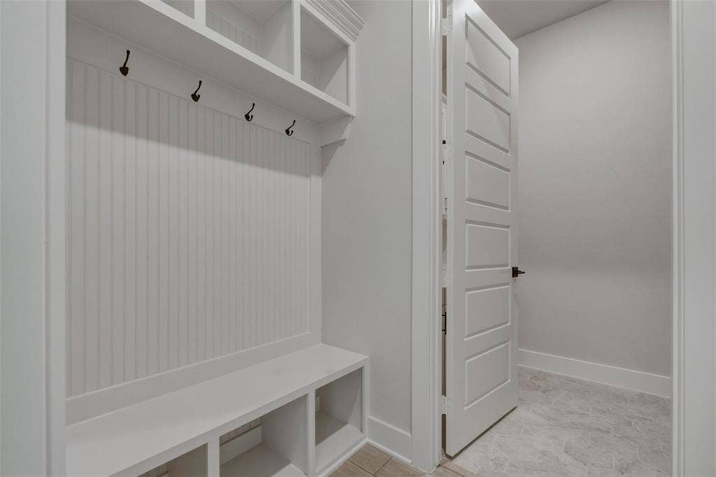 2305 Quartz Street, Krum, TX 76249 Built-in mudroom bench with cubby storage, beadboard paneling, and upper shelving