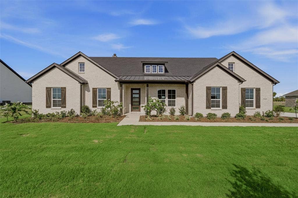 2305 Quartz Street, Krum, TX 76249 Brick exterior with a dark shingle roof, dark wood shutters, and an inviting front entry