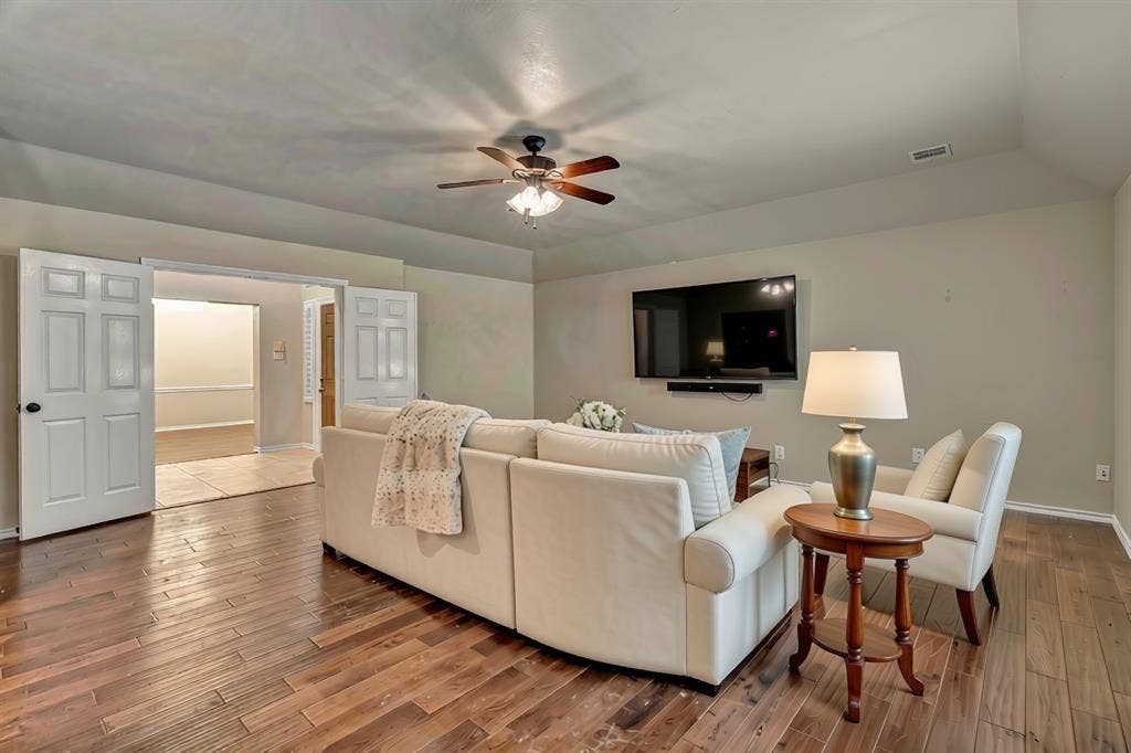 2405 Charlene Drive, Plano, TX 75074 staged with ai with more room behing the sofa for a game table