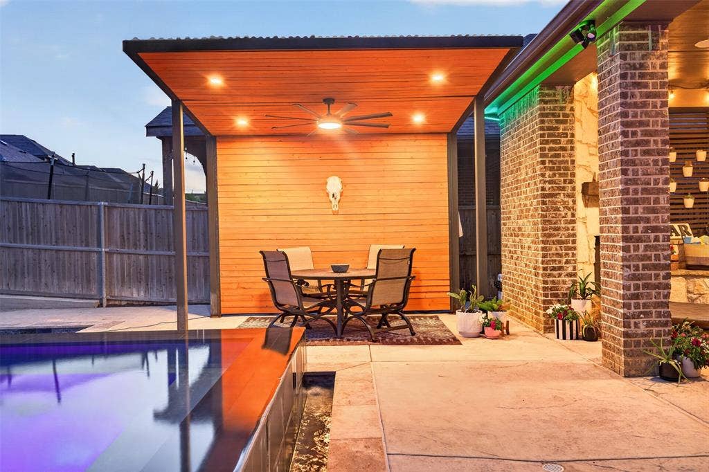 Covered patio overlooks the pool and provides additional space for outdoor dining and entertaining.