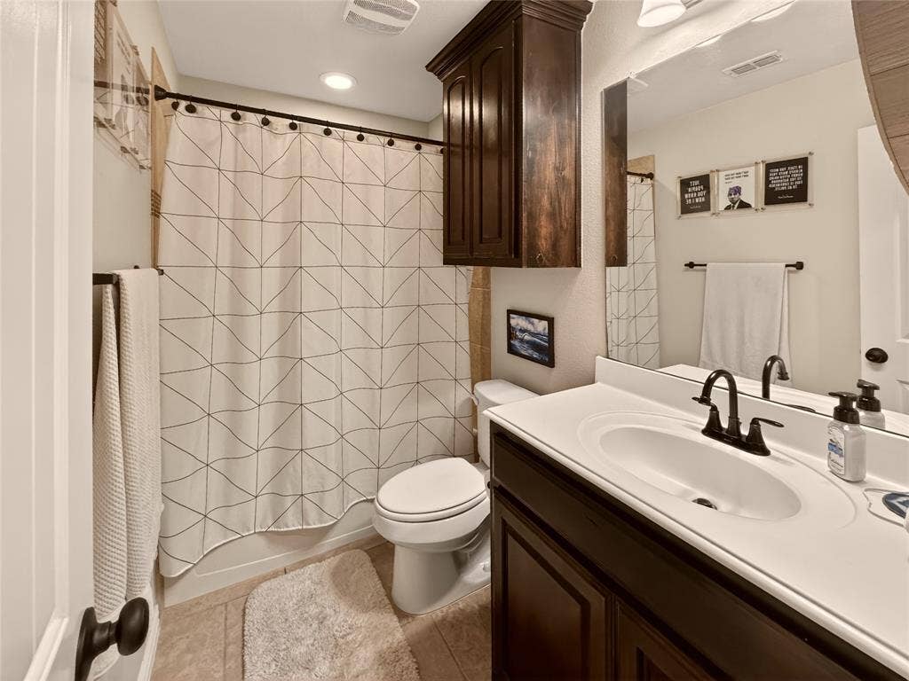 Additional full bathroom includes a tub-shower combination and convenient storage.