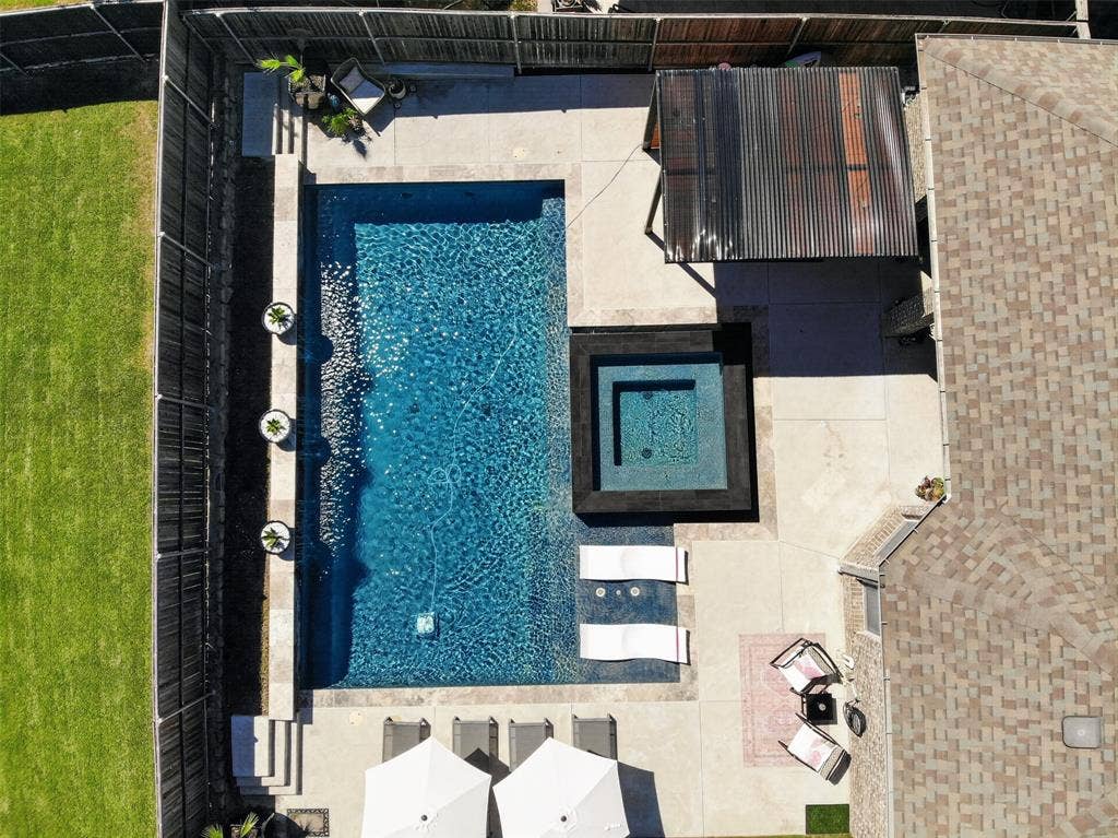Overhead view showcases the pool, spa, sun shelf and surrounding deck.