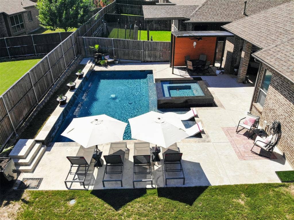 Aerial view highlights the pool, spa, sun shelf and spacious outdoor living areas.