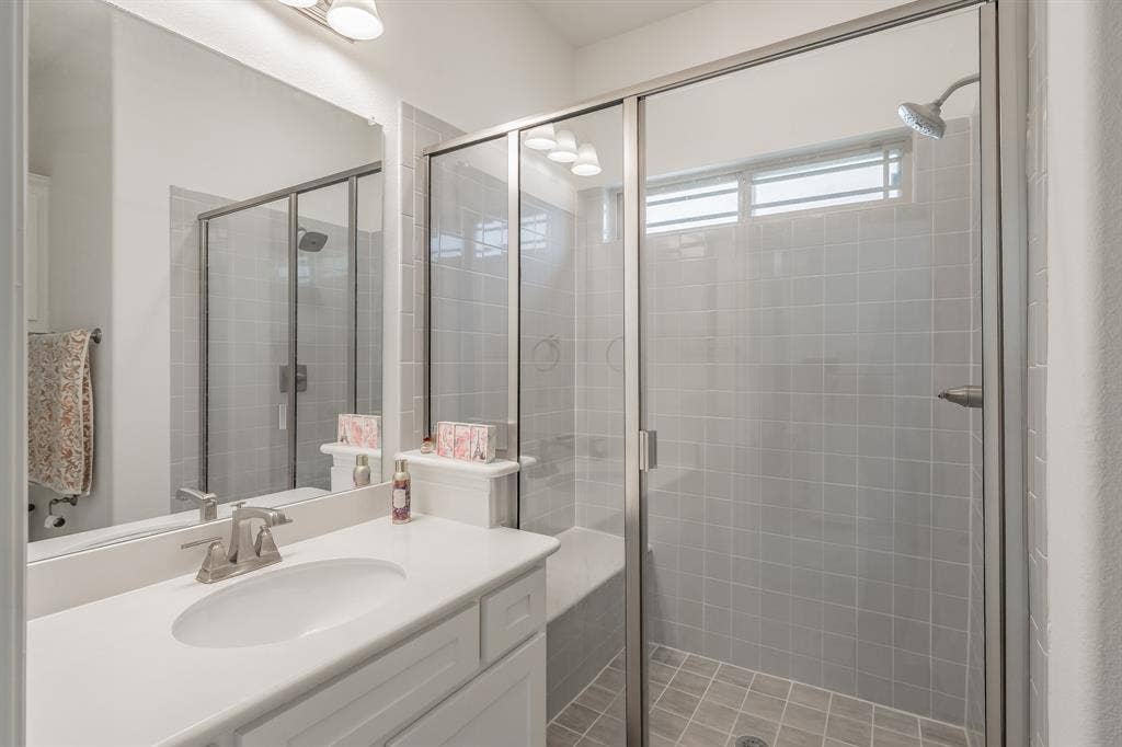 Bathroom featuring vanity and an enclosed shower