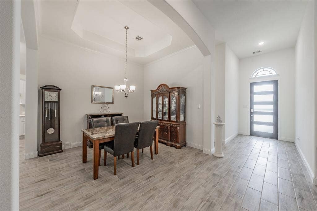 Dining area featuring ornamental molding, space for a larger dining set
