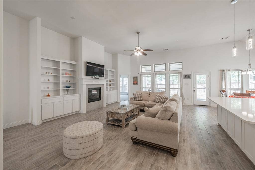 Living room with built in cabinets and gas fireplace