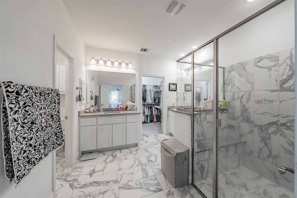 Bathroom featuring large walk in closet