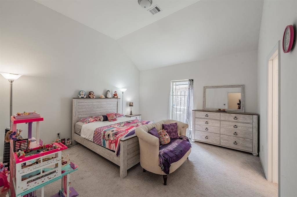 Carpeted bedroom #2 with vaulted ceiling