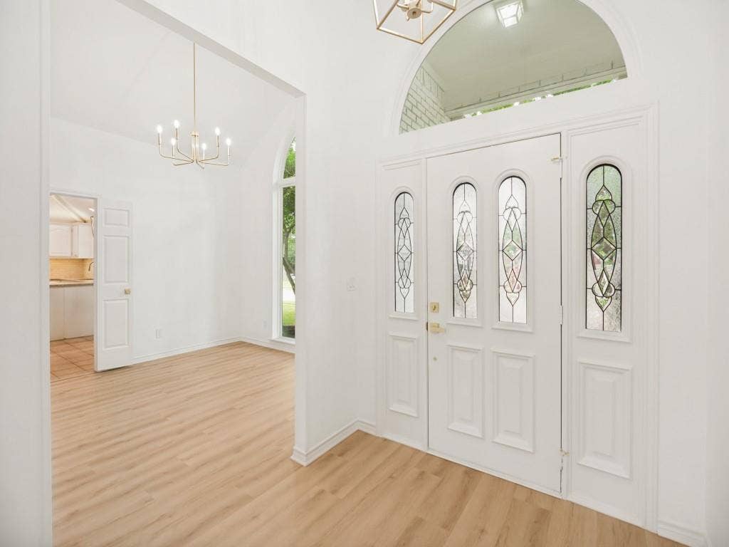 4312 Avonshire Lane, Plano, TX 75093 Grand entryway featuring a double door with decorative glass inserts and an arched transom window
