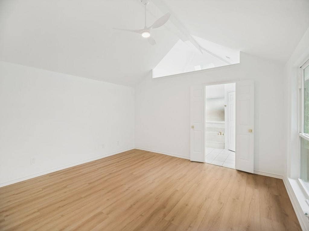 4312 Avonshire Lane, Plano, TX 75093 Vaulted ceiling with a contemporary ceiling fan, wood-finish flooring, and white walls