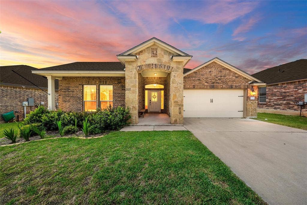 Brick and stone-veneer exterior with an arched entry