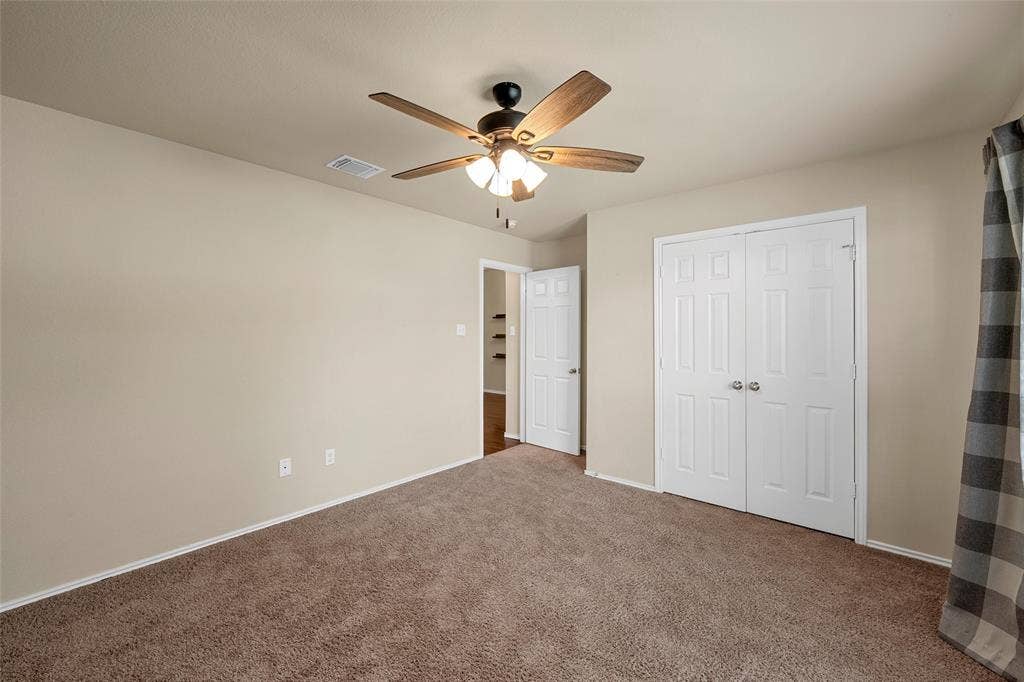 Carpeted room with neutral wall tones
