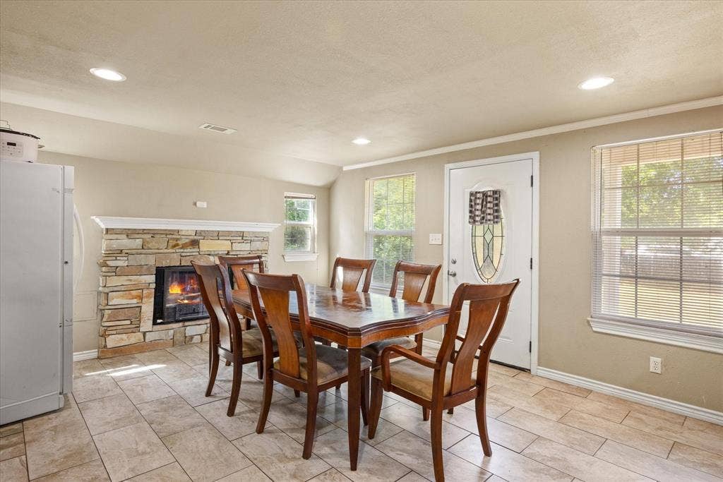 405 Granbury Court, Granbury, TX 76049 Area is being used for dining but could also be a den, with fireplace and a second from entrance.