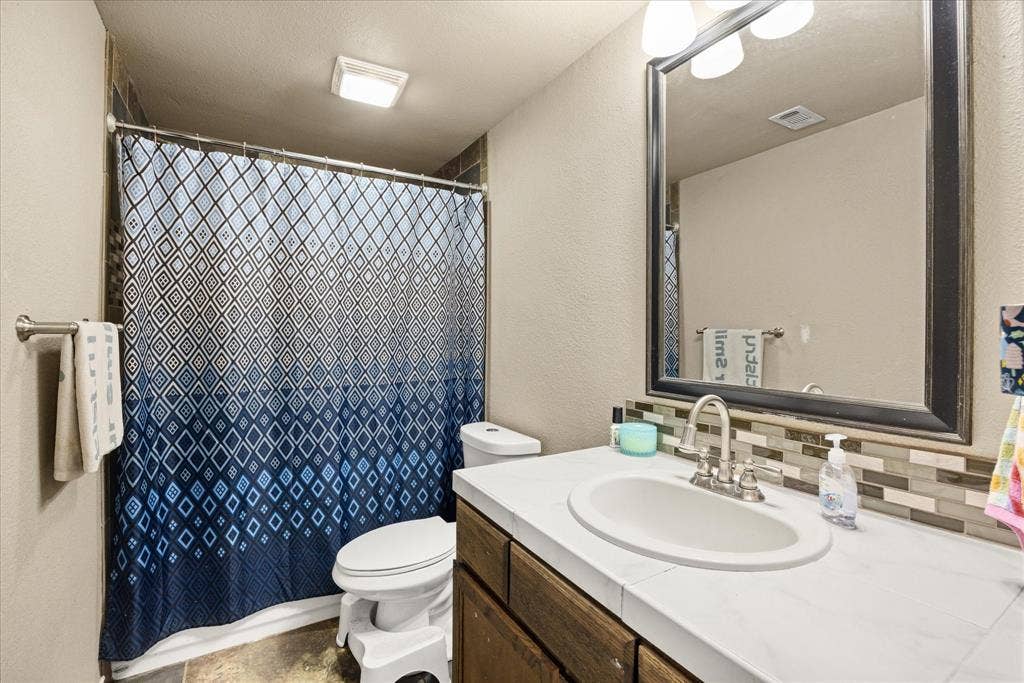 405 Granbury Court, Granbury, TX 76049 Main level bathroom for guests and serves on bedroom.
