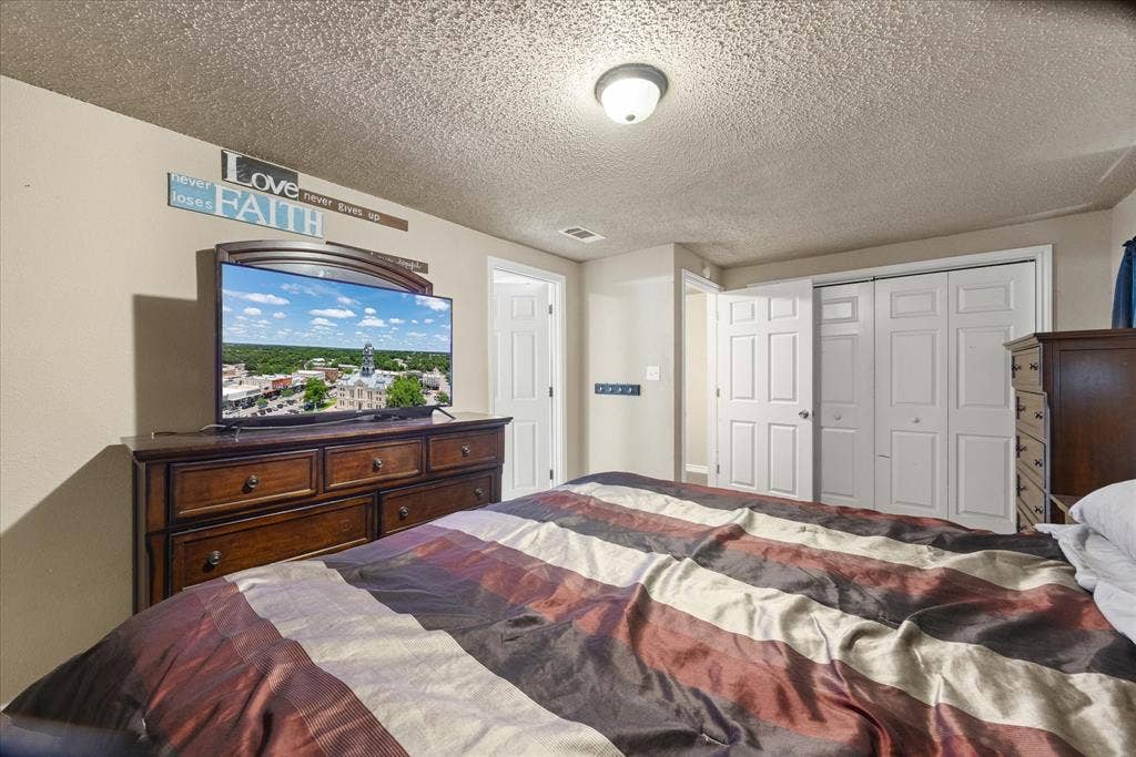 405 Granbury Court, Granbury, TX 76049 Primary bedroom with ensuite bath.