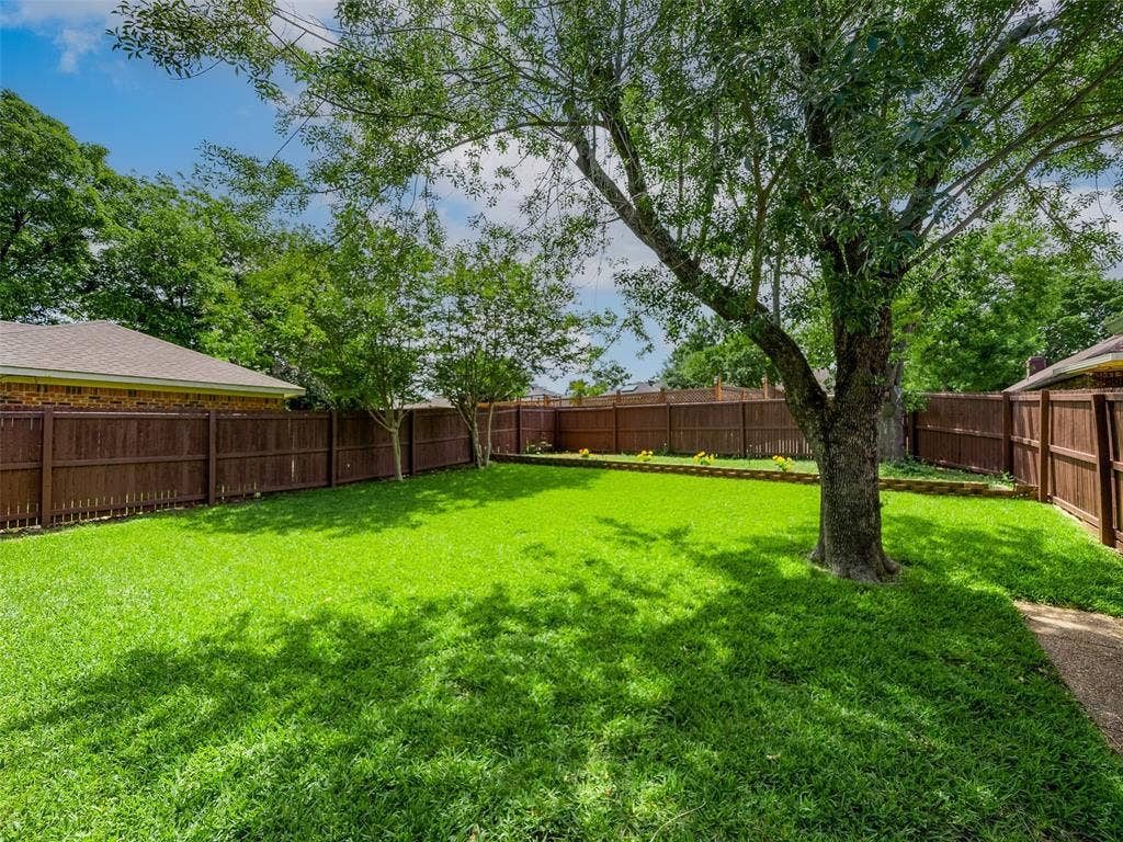 4100 Emerson Drive, Plano, TX 75093 The large, fully fenced backyard provides plenty of grassy space for pets, play, or outdoor entertaining.