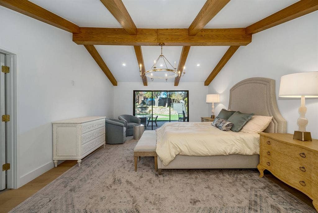 6275 Preston Creek Drive, Dallas, TX 75240 Bedroom with a chandelier and light wood-style floors