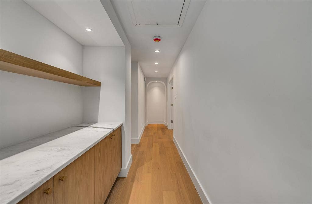 6275 Preston Creek Drive, Dallas, TX 75240 Hall featuring light wood-style floors, recessed lighting, and arched walkways