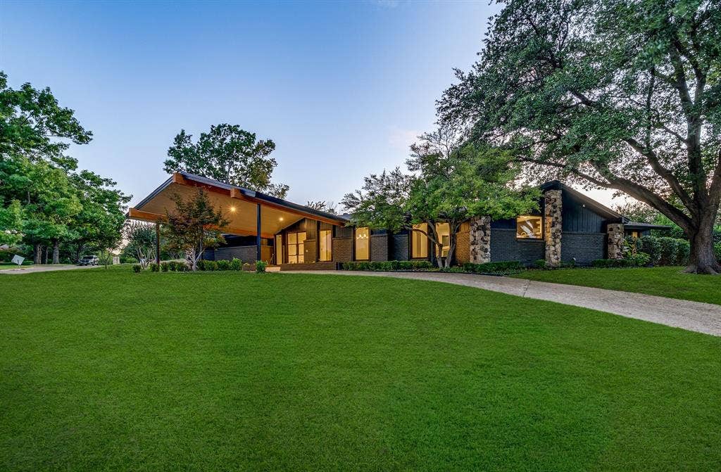 6275 Preston Creek Drive, Dallas, TX 75240 Mid-century home featuring a front lawn, driveway, and stone siding