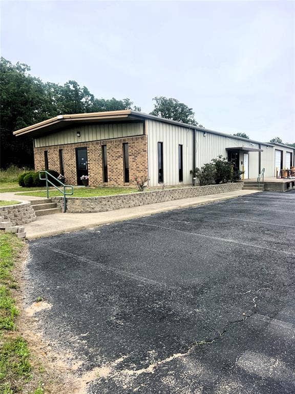 6275 Fm 59, Athens, TX 75751 Commercial building featuring a brick facade and vertical metal siding
