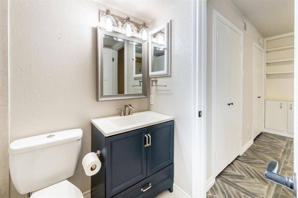 300 Rush Creek Drive, #A2, Heath, TX 75032 Bathroom featuring a dark blue vanity with a white countertop and integrated sink