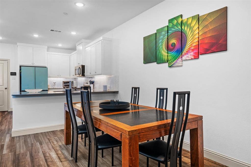 Entrance leads into spacious dining area that is open to living and kitchen.