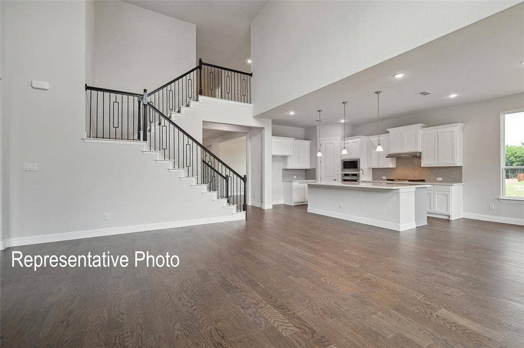 2297 Slate Drive, Waxahachie, TX 75167 Open-concept living area with high ceilings and wood-finish flooring