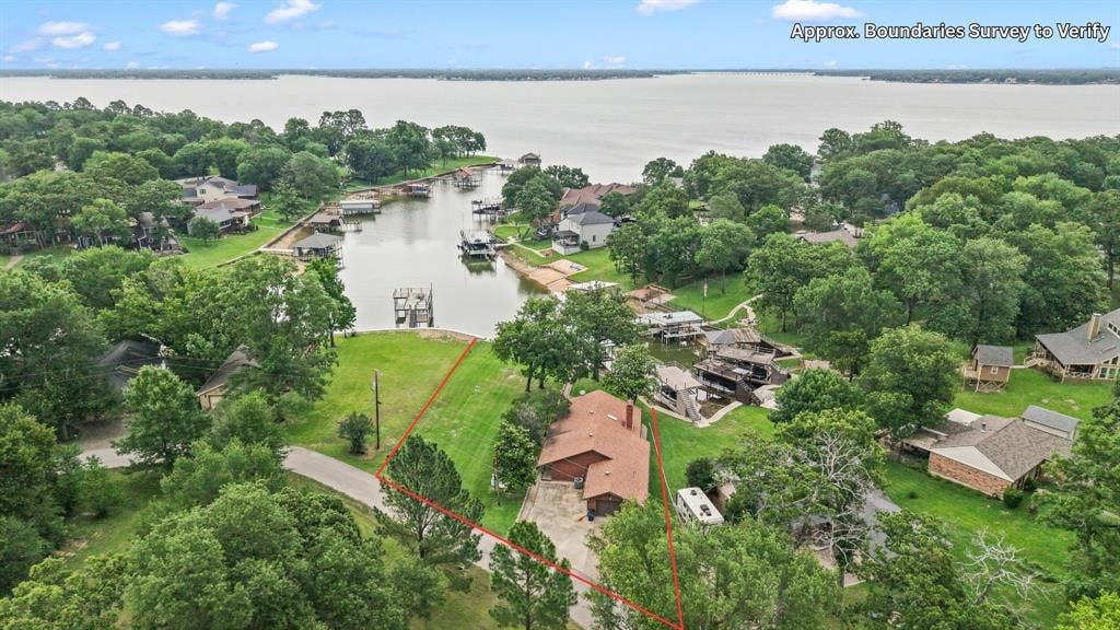1524 Villa Cove Drive, Tool, TX 75143 Charming single-story lake home with wraparound covered porch and beautifully landscaped lots, perfectly situated on 120 feet of waterfront.