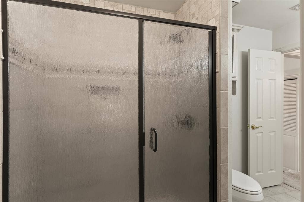 1524 Villa Cove Drive, Tool, TX 75143 Large walk in secondary bathroom shower featuring durable finishes and functional design for family or guests.