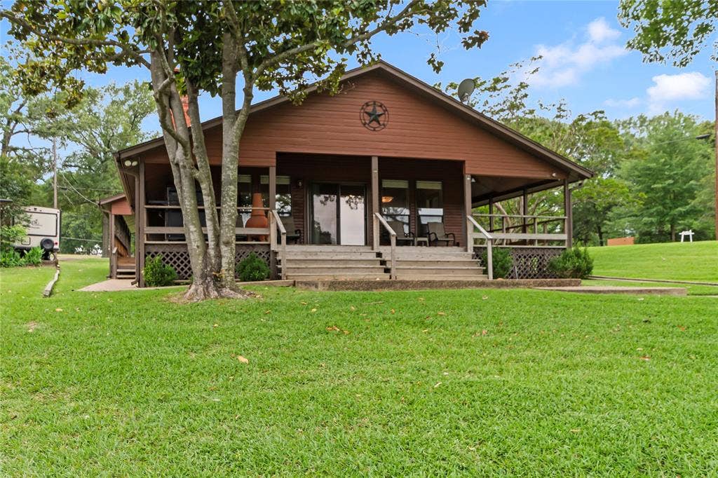 1524 Villa Cove Drive, Tool, TX 75143 Inviting back porch overlooking the yard and waterfront, ideal for morning coffee, relaxing afternoons, or entertaining with scenic views.